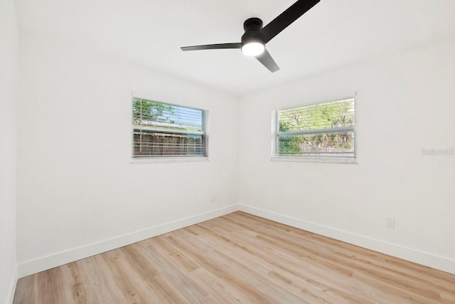 1886 San Mateo Dr, Dunedin, FL 34698 - spare room featuring baseboards, wood finished floors, and ceiling fan