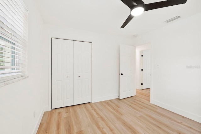 1886 San Mateo Dr, Dunedin, FL 34698 - unfurnished bedroom with visible vents, a ceiling fan, light wood-style floors, a closet, and baseboards
