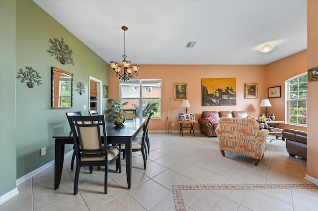 dining room with visible vents, baseboards, a chandelier, and light tile patterned floors