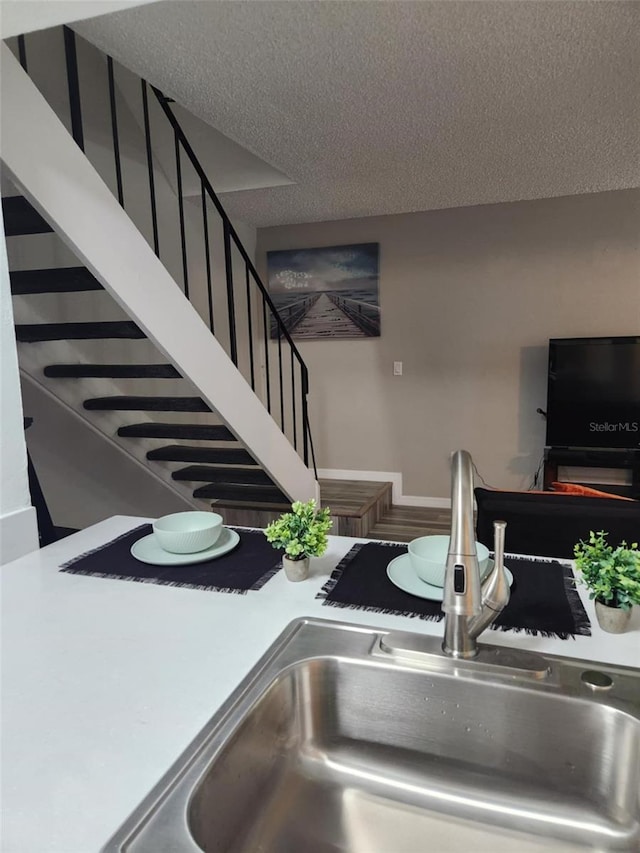 interior details with a textured ceiling and a sink