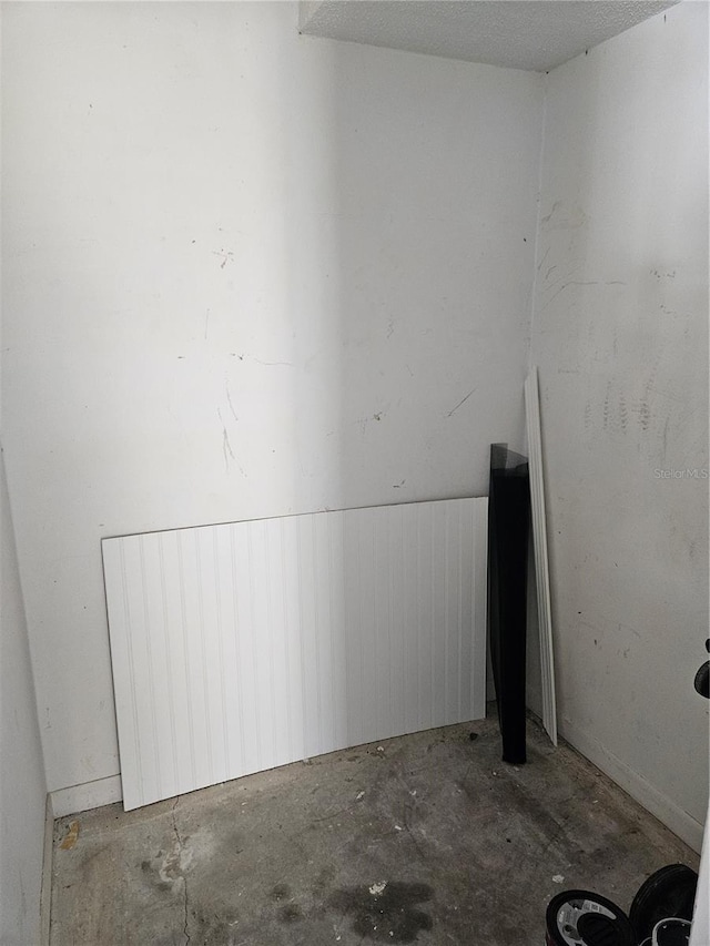 unfurnished room featuring concrete flooring