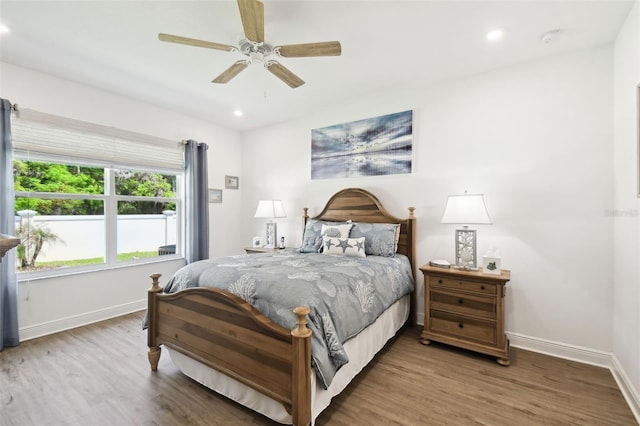 bedroom featuring wood finished floors, baseboards, a ceiling fan, and recessed lighting