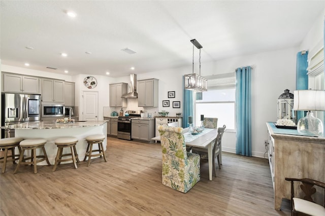 dining space featuring light wood-type flooring, baseboards, visible vents, and recessed lighting