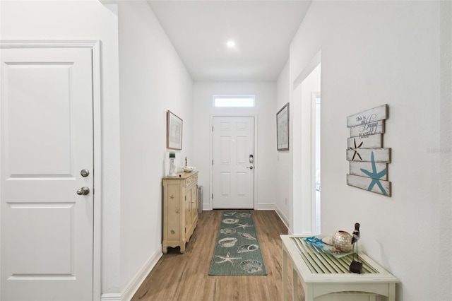entryway featuring baseboards and light wood finished floors