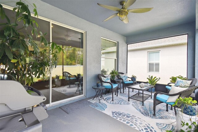 sunroom featuring an outdoor living space and ceiling fan
