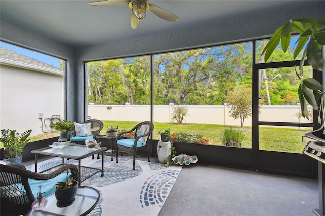 sunroom / solarium with plenty of natural light, outdoor lounge area, and a ceiling fan