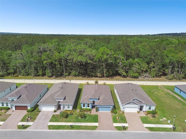 birds eye view of property featuring a forest view and a residential view