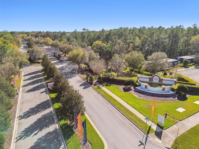 birds eye view of property featuring a forest view