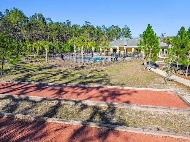 exterior space featuring an outdoor pool and fence
