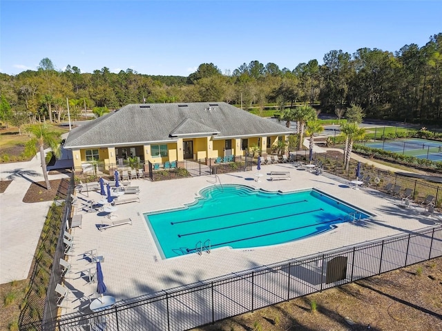 community pool featuring fence and a patio