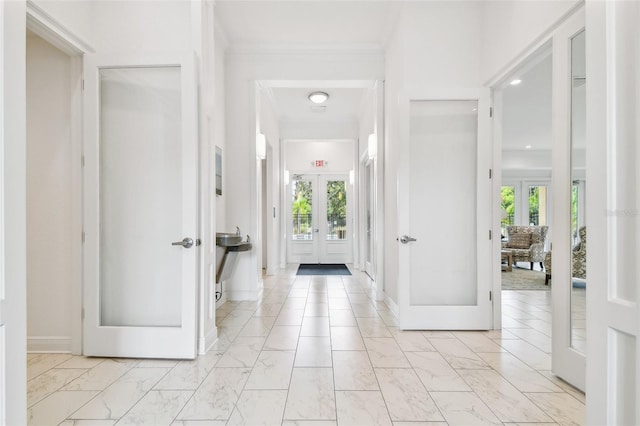 entrance foyer featuring french doors, marble finish floor, and baseboards
