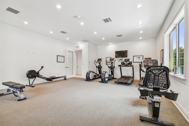 workout area with baseboards, visible vents, and recessed lighting
