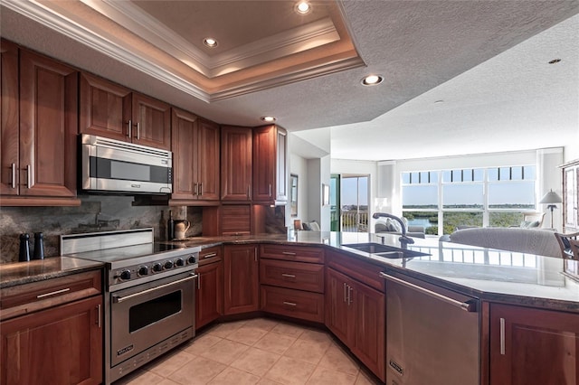 kitchen with ornamental molding, open floor plan, decorative backsplash, stainless steel appliances, and a sink