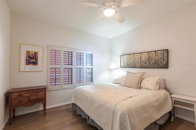 bedroom featuring wood finished floors, ceiling fan, and baseboards