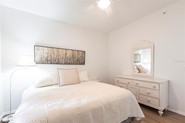 bedroom featuring baseboards, a ceiling fan, and wood finished floors