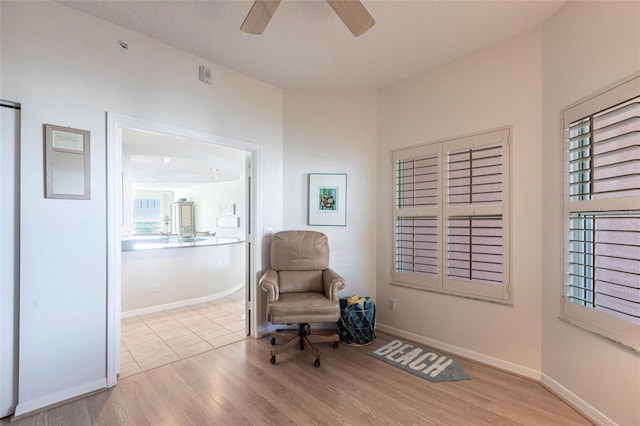 unfurnished room featuring wood finished floors, ceiling fan, and baseboards