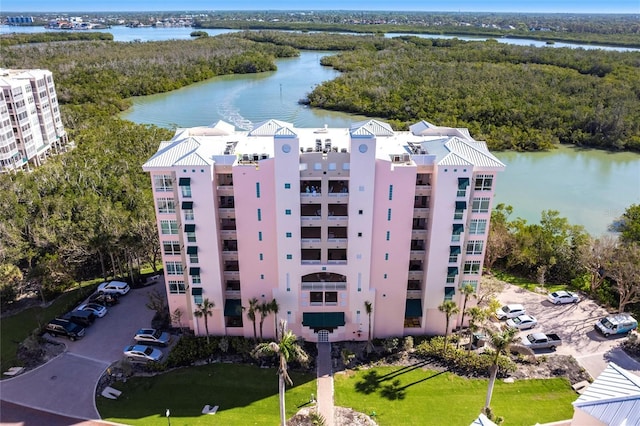 bird's eye view with a water view and a wooded view