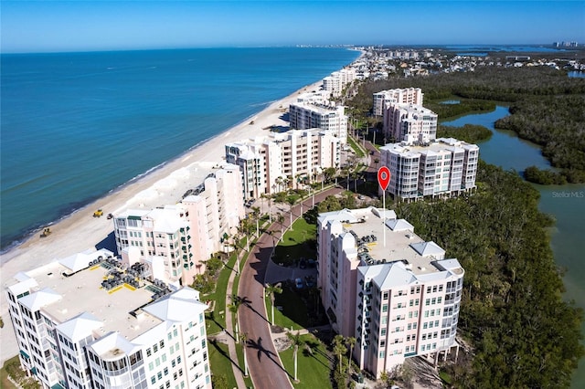 birds eye view of property featuring a water view and a beach view