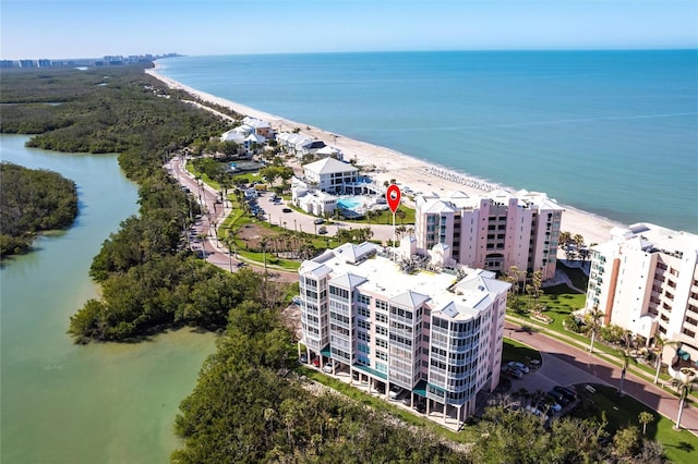 drone / aerial view featuring a beach view and a water view