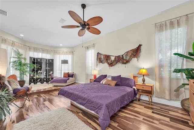 bedroom featuring baseboards, recessed lighting, wood finished floors, and ceiling fan