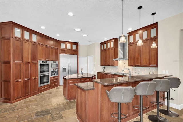 5807 Thoreau Pl, Lithia, FL 33547 - kitchen with appliances with stainless steel finishes, backsplash, a peninsula, recessed lighting, and a kitchen island