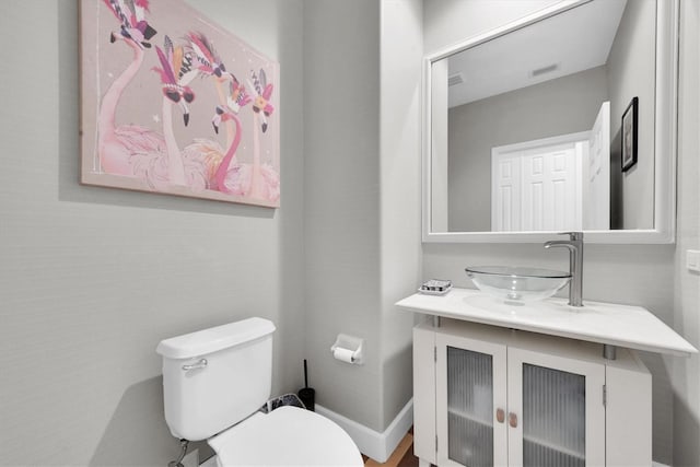 5807 Thoreau Pl, Lithia, FL 33547 - half bathroom featuring toilet, vanity, and baseboards
