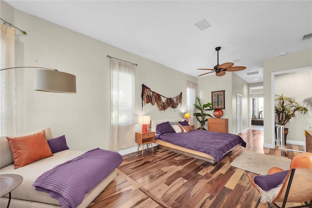 5807 Thoreau Pl, Lithia, FL 33547 - bedroom featuring wood finished floors, multiple windows, ceiling fan, and baseboards