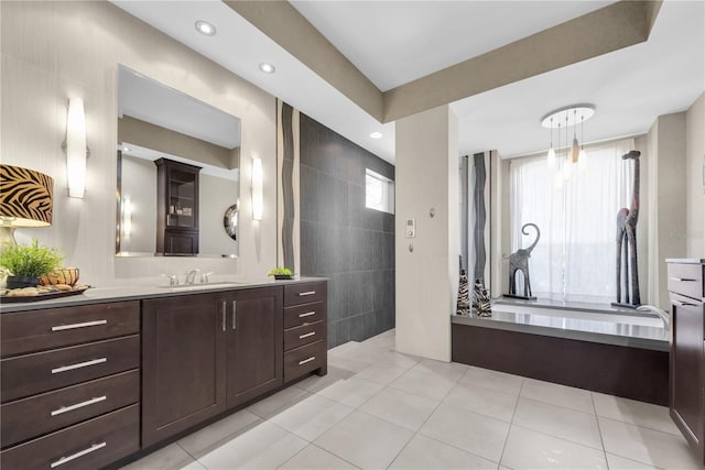5807 Thoreau Pl, Lithia, FL 33547 - bathroom featuring vanity, tile patterned flooring, a bath, tile walls, and recessed lighting