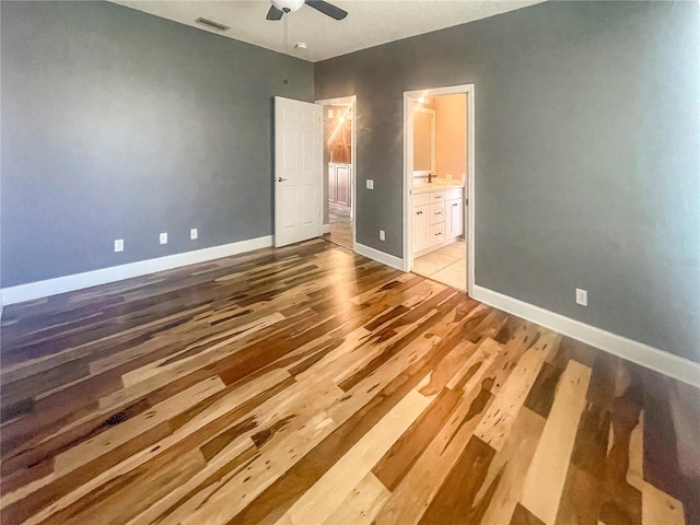 5807 Thoreau Pl, Lithia, FL 33547 - unfurnished bedroom featuring light wood finished floors, baseboards, ensuite bathroom, and a ceiling fan