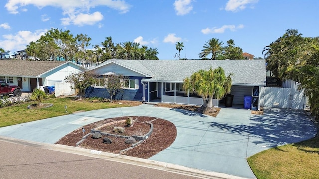 7919 Causeway Blvd S, Saint Petersburg, FL 33707 - ranch-style home with curved driveway and a shingled roof