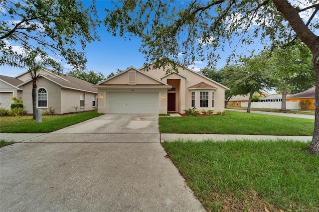 11626 Pure Pebble Dr, Riverview, FL 33569 - ranch-style house featuring stucco siding, driveway, a front yard, and an attached garage