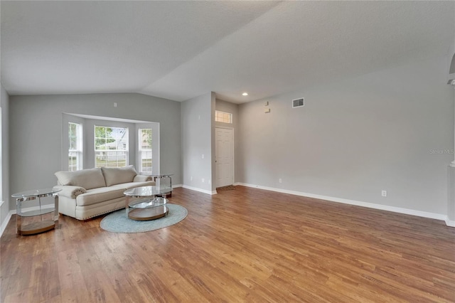 11626 Pure Pebble Dr, Riverview, FL 33569 - living area featuring light wood-type flooring, lofted ceiling, and baseboards
