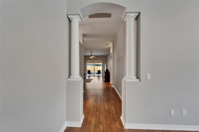 11626 Pure Pebble Dr, Riverview, FL 33569 - corridor with ornate columns, arched walkways, wood finished floors, and baseboards