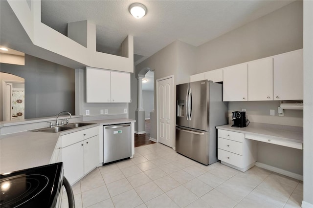 11626 Pure Pebble Dr, Riverview, FL 33569 - kitchen with appliances with stainless steel finishes, a sink, light countertops, white cabinetry, and a textured ceiling