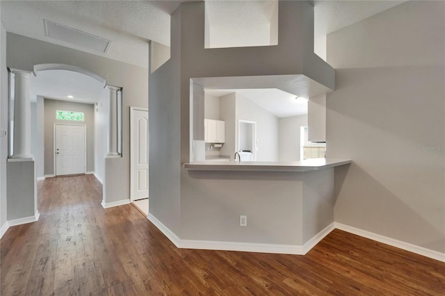 11626 Pure Pebble Dr, Riverview, FL 33569 - hall with ornate columns, dark wood-style flooring, baseboards, and arched walkways