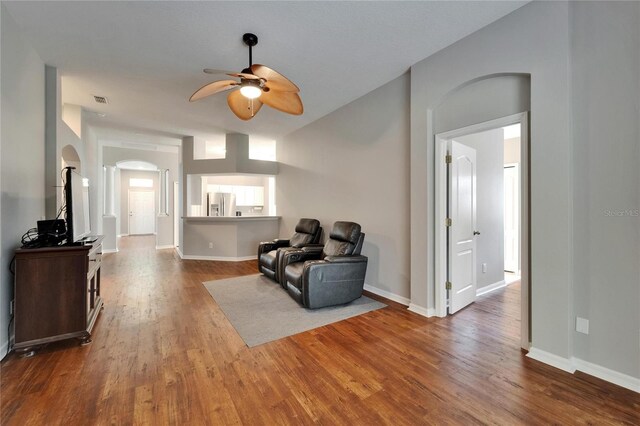 11626 Pure Pebble Dr, Riverview, FL 33569 - sitting room featuring arched walkways, ceiling fan, wood finished floors, and baseboards