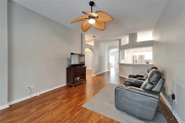 11626 Pure Pebble Dr, Riverview, FL 33569 - living room featuring arched walkways, ceiling fan, wood finished floors, and baseboards