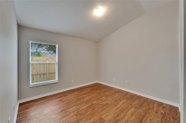 11626 Pure Pebble Dr, Riverview, FL 33569 - empty room featuring wood finished floors, baseboards, and a textured ceiling