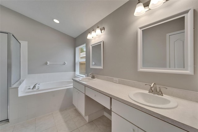 11626 Pure Pebble Dr, Riverview, FL 33569 - bathroom featuring tile patterned flooring, vaulted ceiling, a garden tub, and double vanity