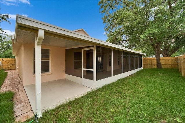 11626 Pure Pebble Dr, Riverview, FL 33569 - back of house with stucco siding, a sunroom, and a patio