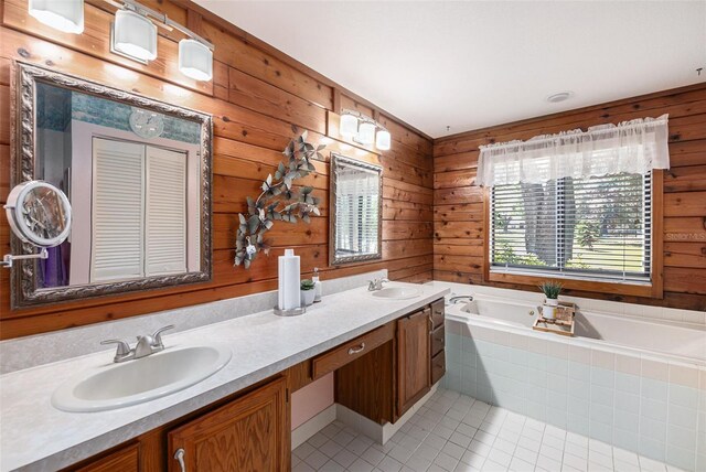 7157 Quail Hollow Blvd, Wesley Chapel, FL 33544 - full bath with tile patterned flooring, a garden tub, double vanity, and wooden walls