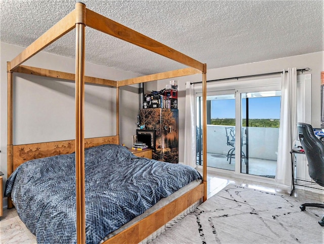 bedroom with access to outside and a textured ceiling