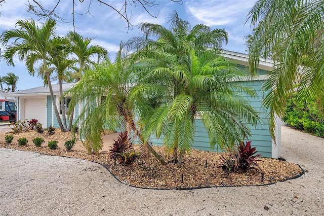 view of side of property with driveway and a garage