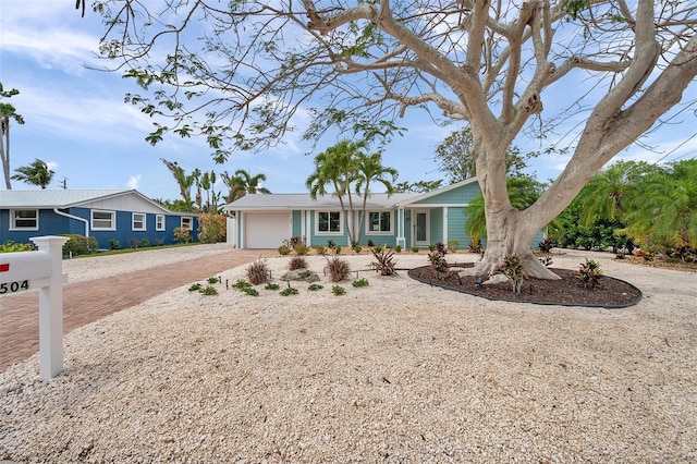ranch-style house with a garage and driveway