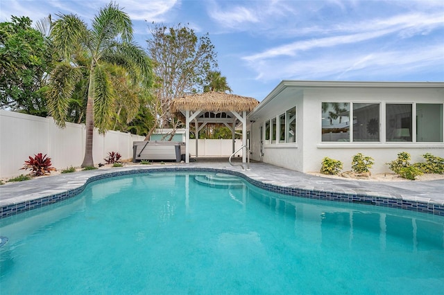 view of swimming pool with a gazebo, a fenced backyard, a fenced in pool, and a patio area