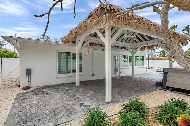 view of patio featuring a gazebo, fence, and a gate