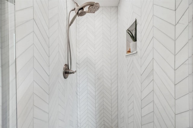 interior details featuring a tile shower