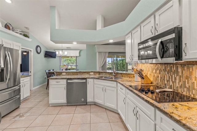 kitchen featuring a sink, white cabinetry, light tile patterned flooring, and stainless steel appliances