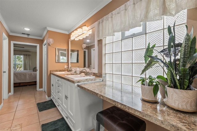 bathroom featuring crown molding, connected bathroom, a sink, and tile patterned flooring