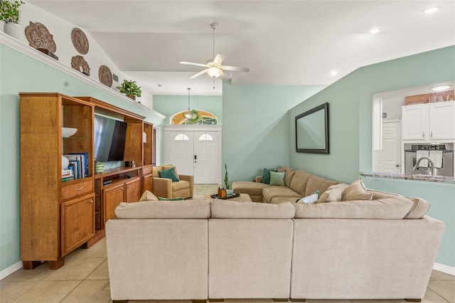 living area featuring a ceiling fan, recessed lighting, baseboards, light tile patterned flooring, and vaulted ceiling